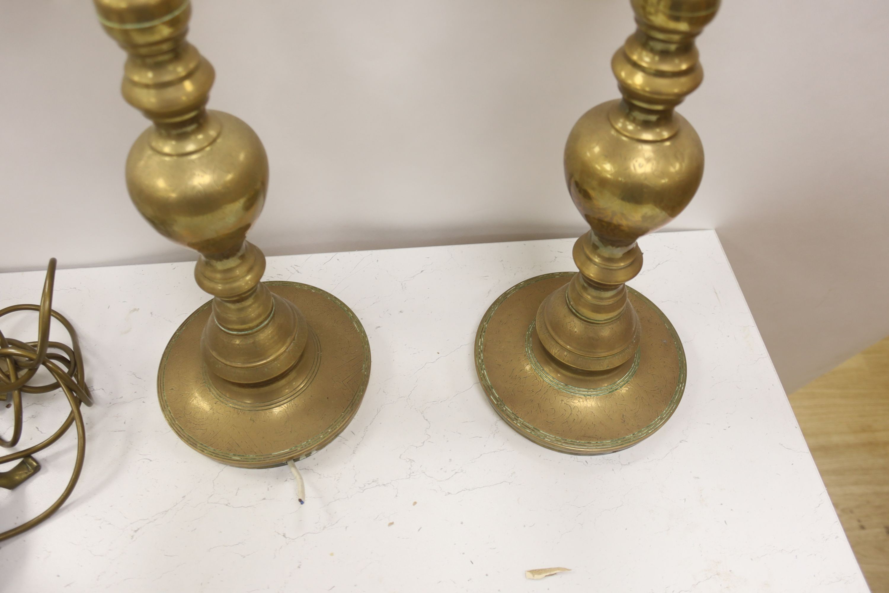 A pair of Benares engraved brass floor lamps 89cm